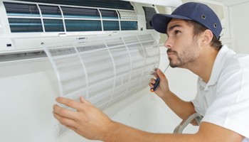 man-inspecting-air-conditioning-unit-heating-and-cooling